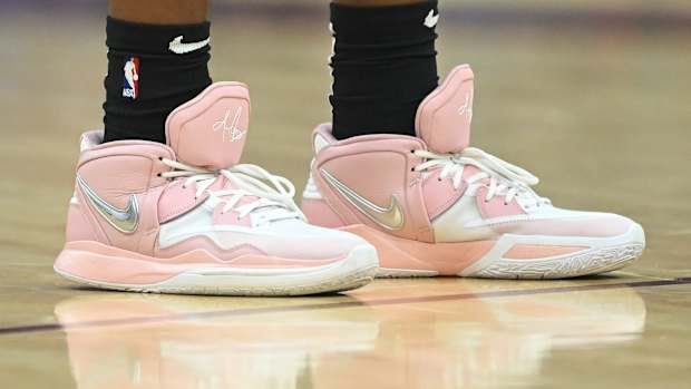 View of pink and white Nike Kyrie shoes.